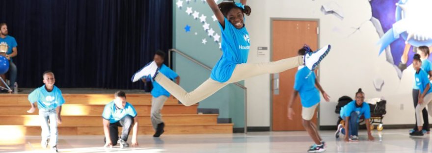 Girl jumping in the air during creative class activity