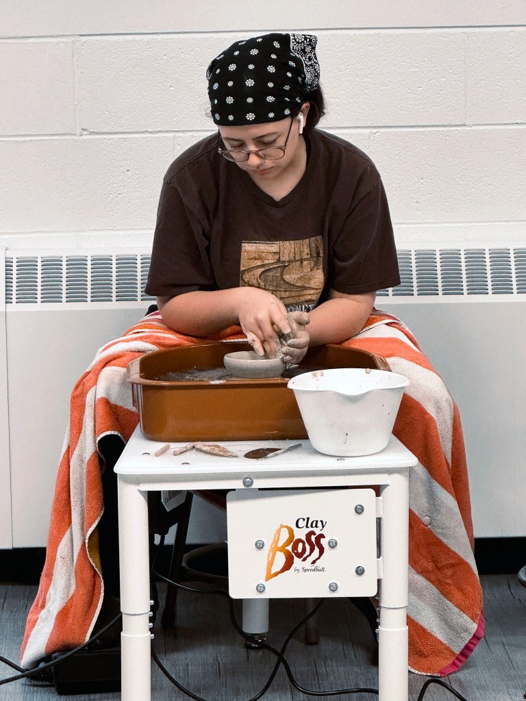 Greencastle High School student working at a pottery where in art class.